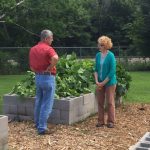Two people discussing community garden.